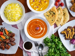 A table topped with lots of plates of food