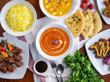 A table topped with lots of plates of food