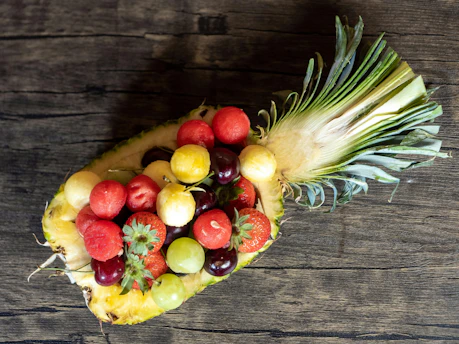 A pineapple filled with lots of different types of fruit