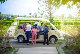 A group of people standing in front of a van