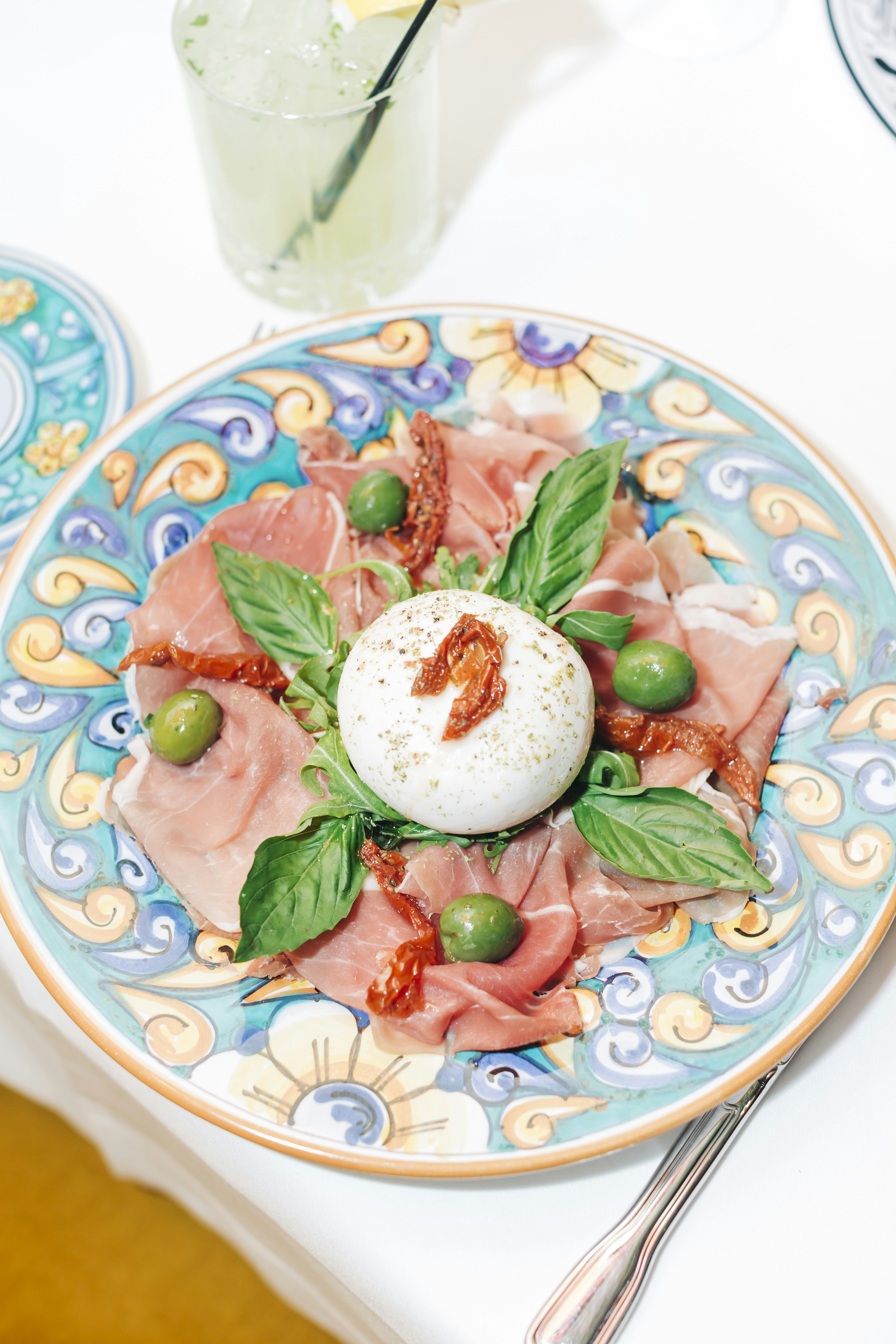 A plate of food on a table with utensils