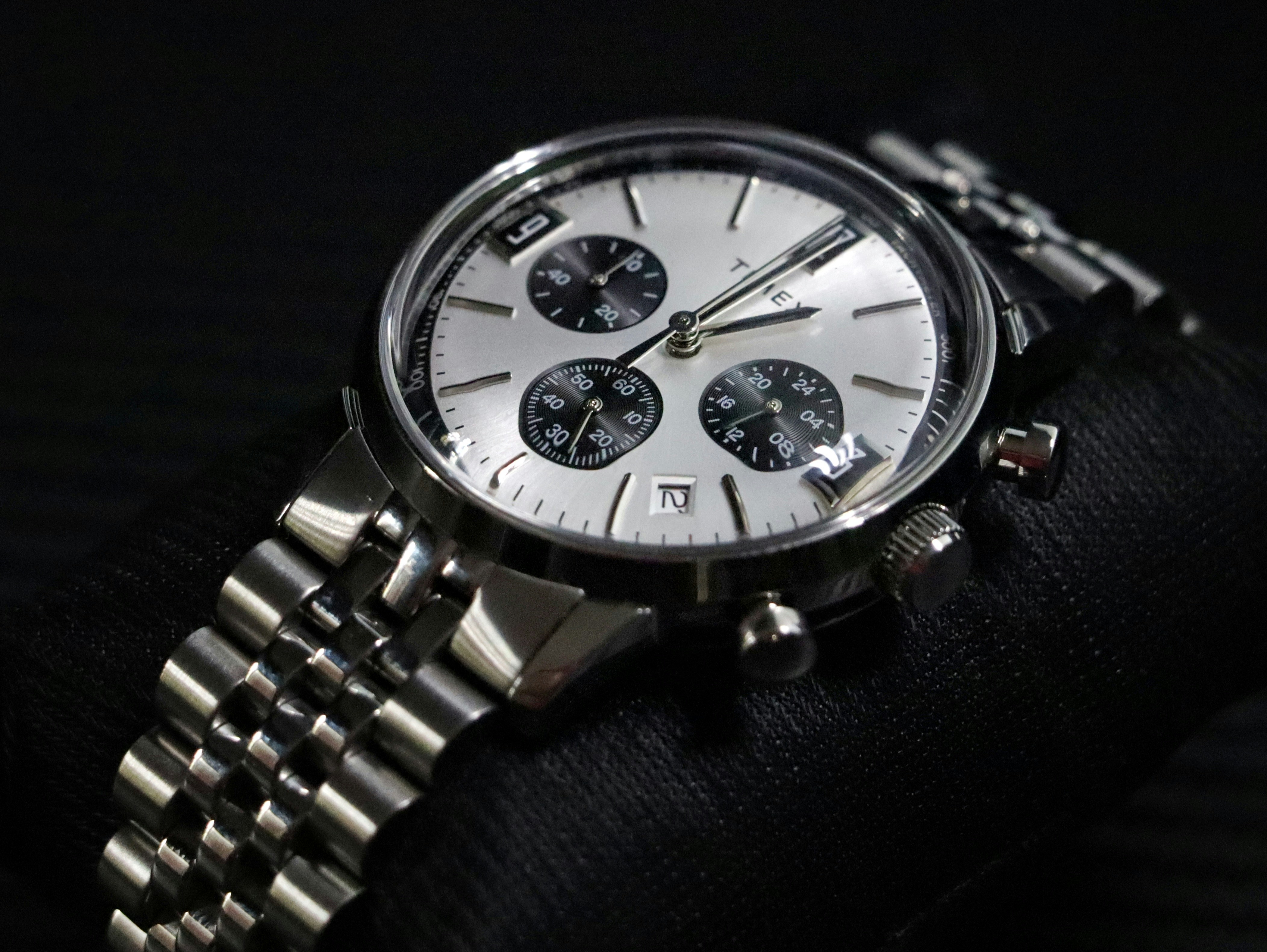 A close up of a watch on a black background