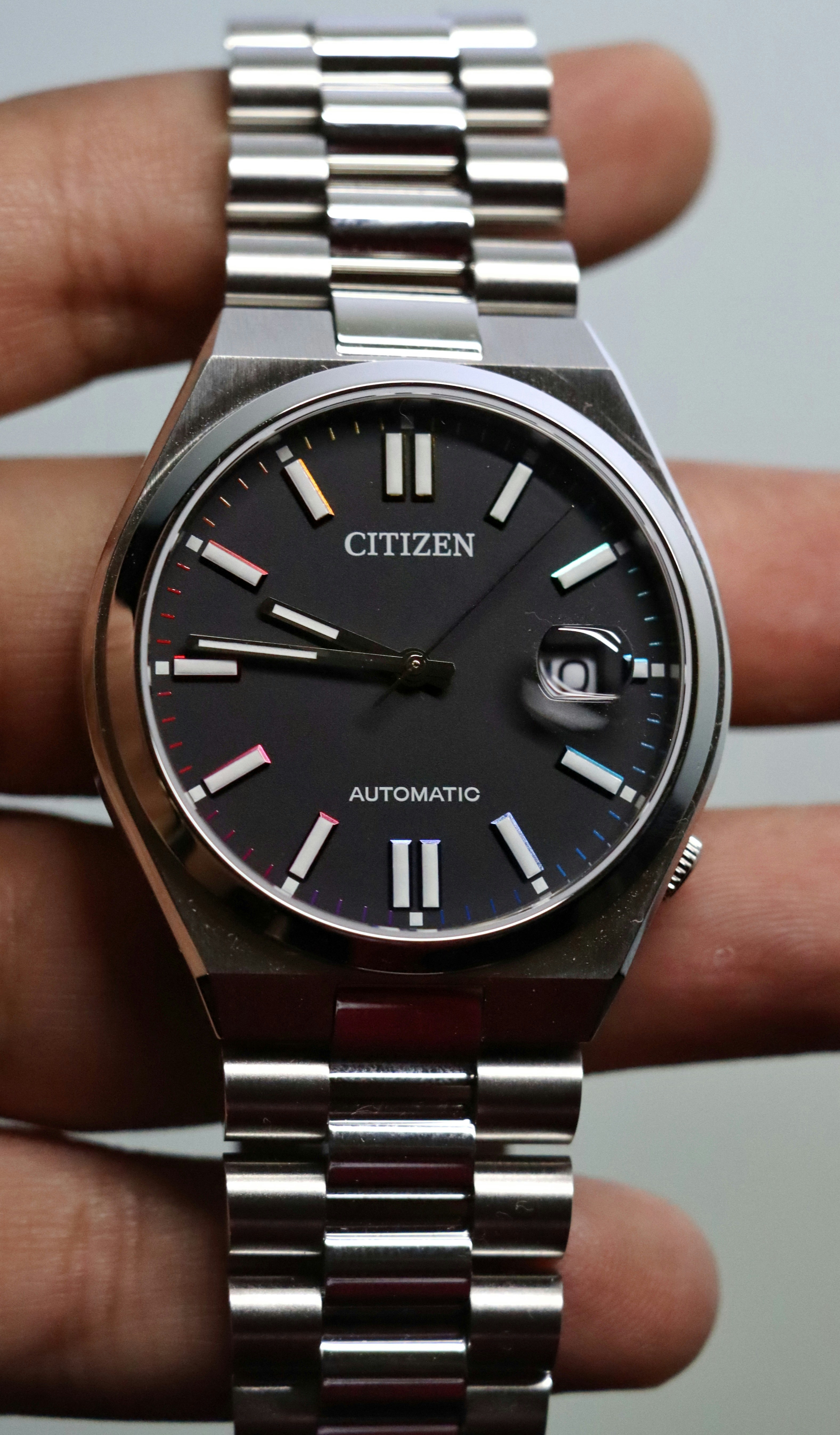 A close up of a person holding a watch