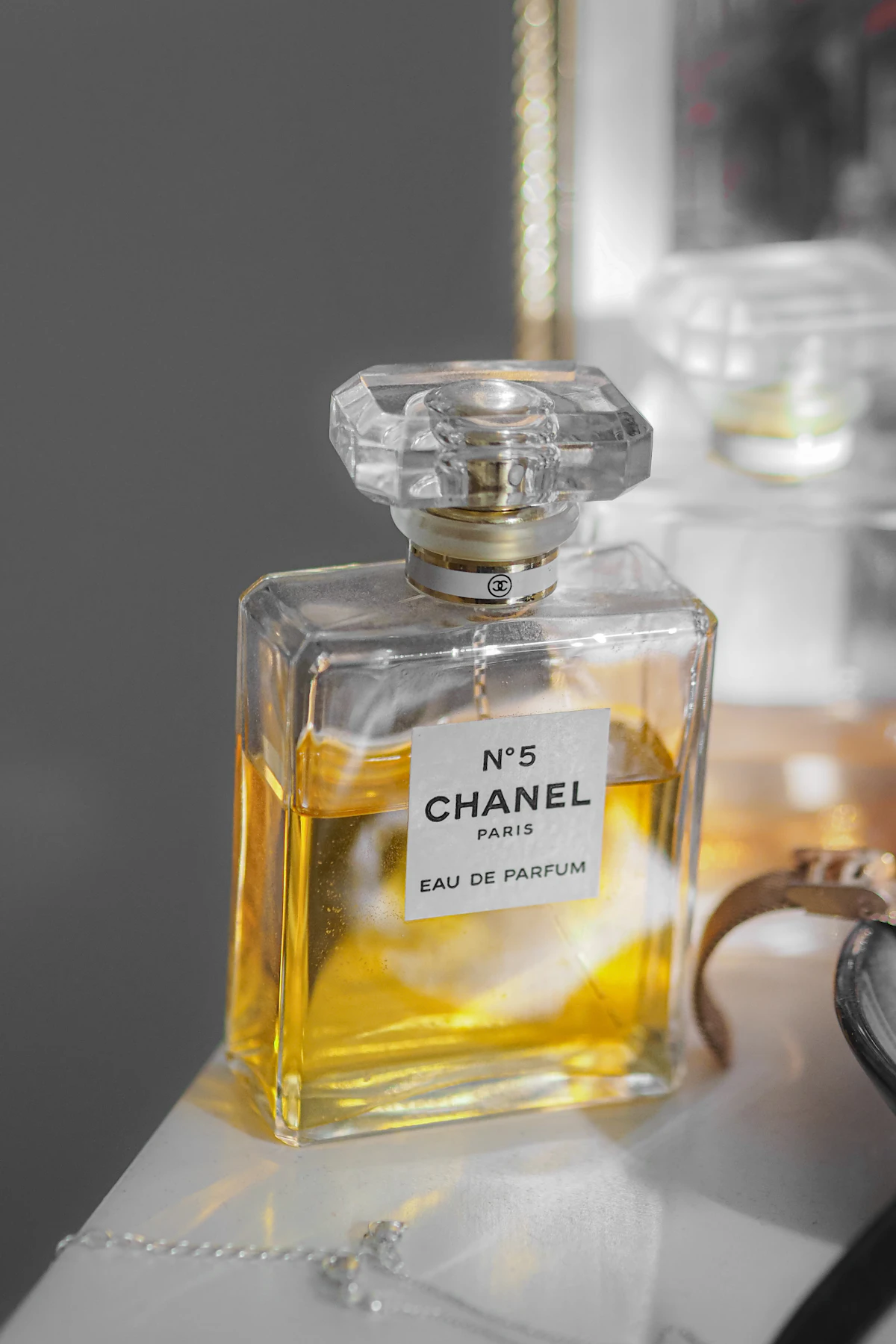 Classic Chanel No.5 perfume bottle with gold cap on white background