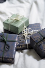 A group of wrapped presents sitting on top of a bed