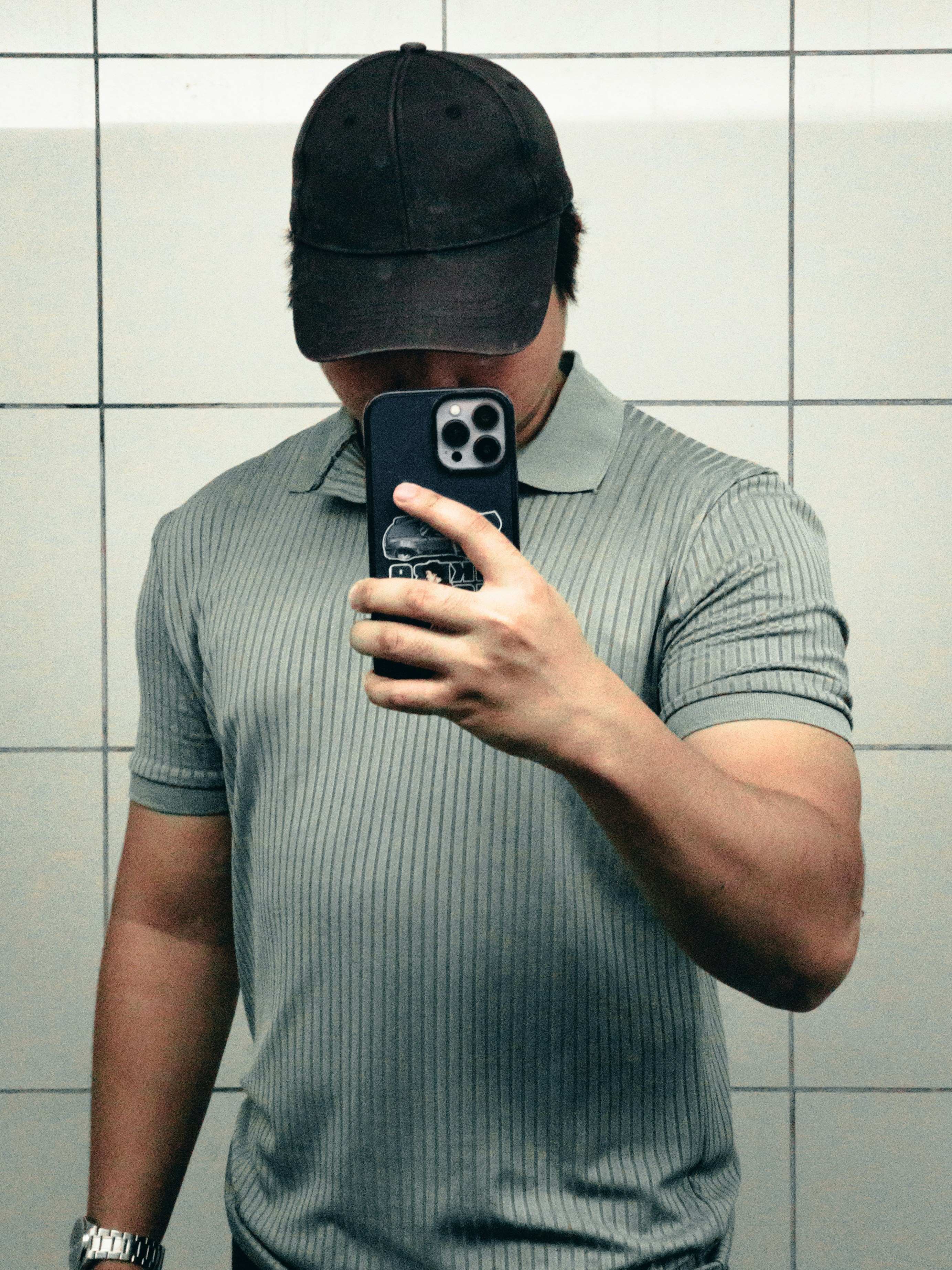 A man taking a selfie in a bathroom mirror
