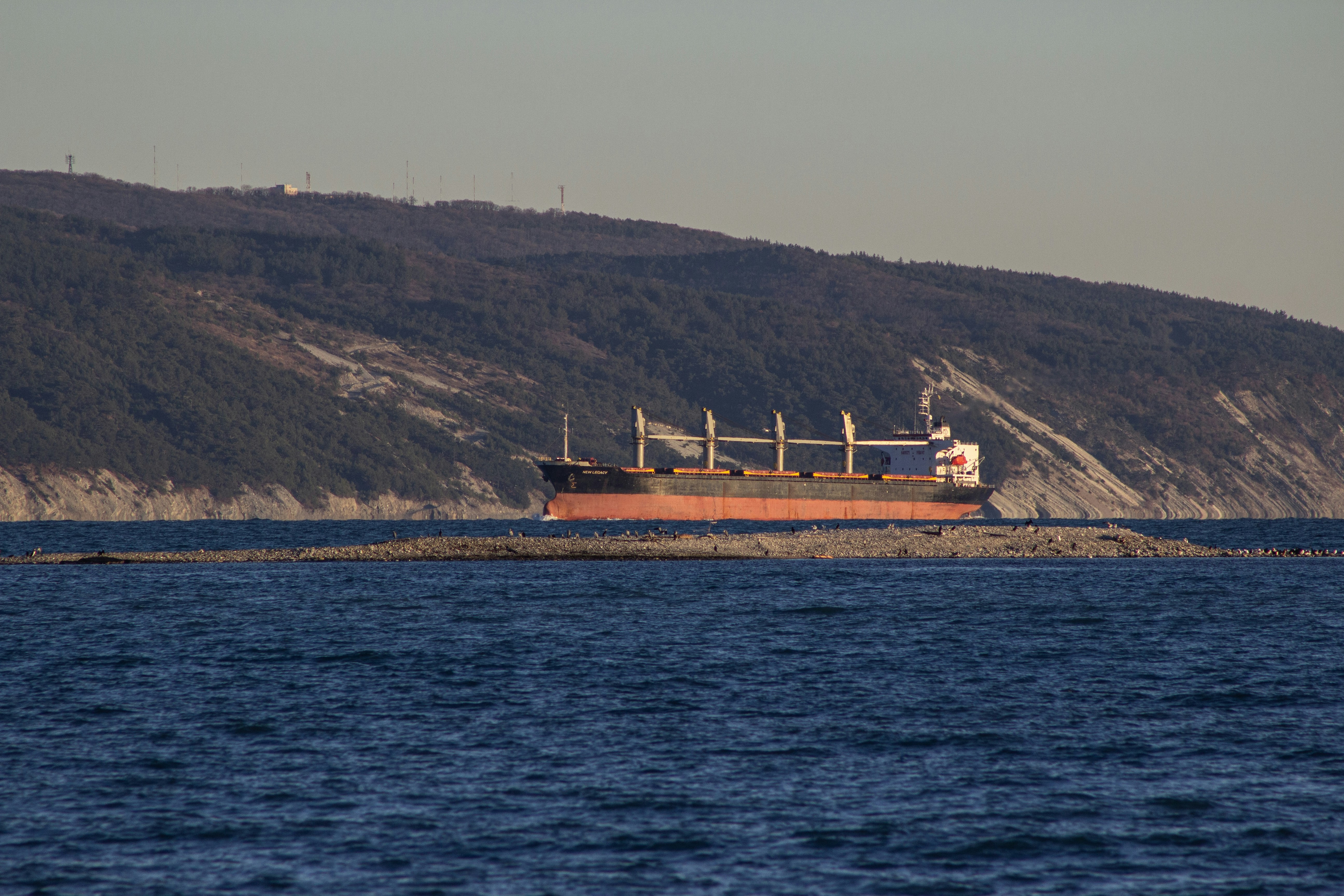 A large boat floating on top of a large body of water