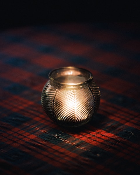 A lit candle sitting on top of a table