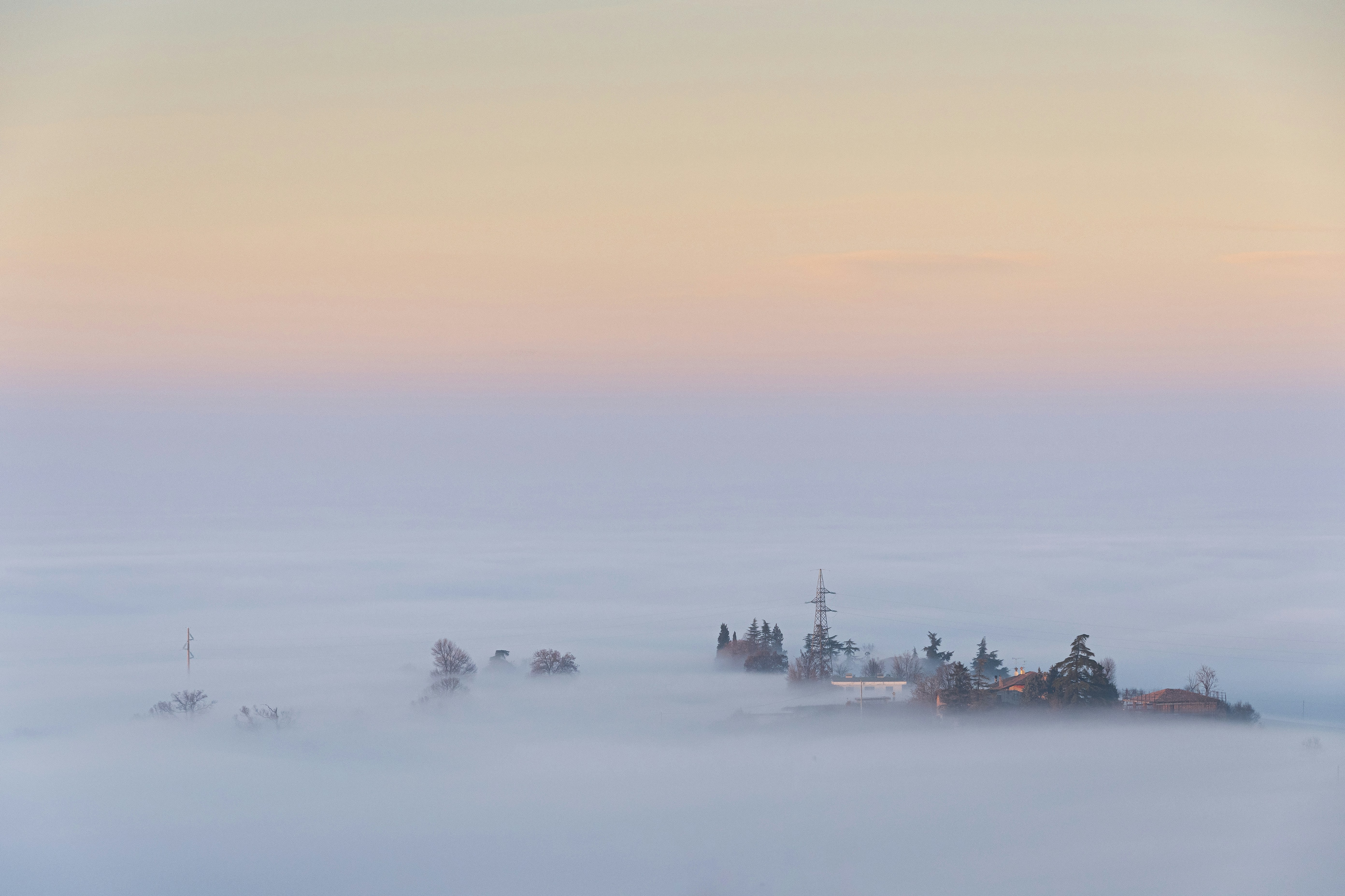 A castle in the middle of a foggy sky