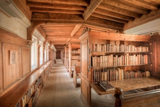 A long room with a lot of books on the shelves
