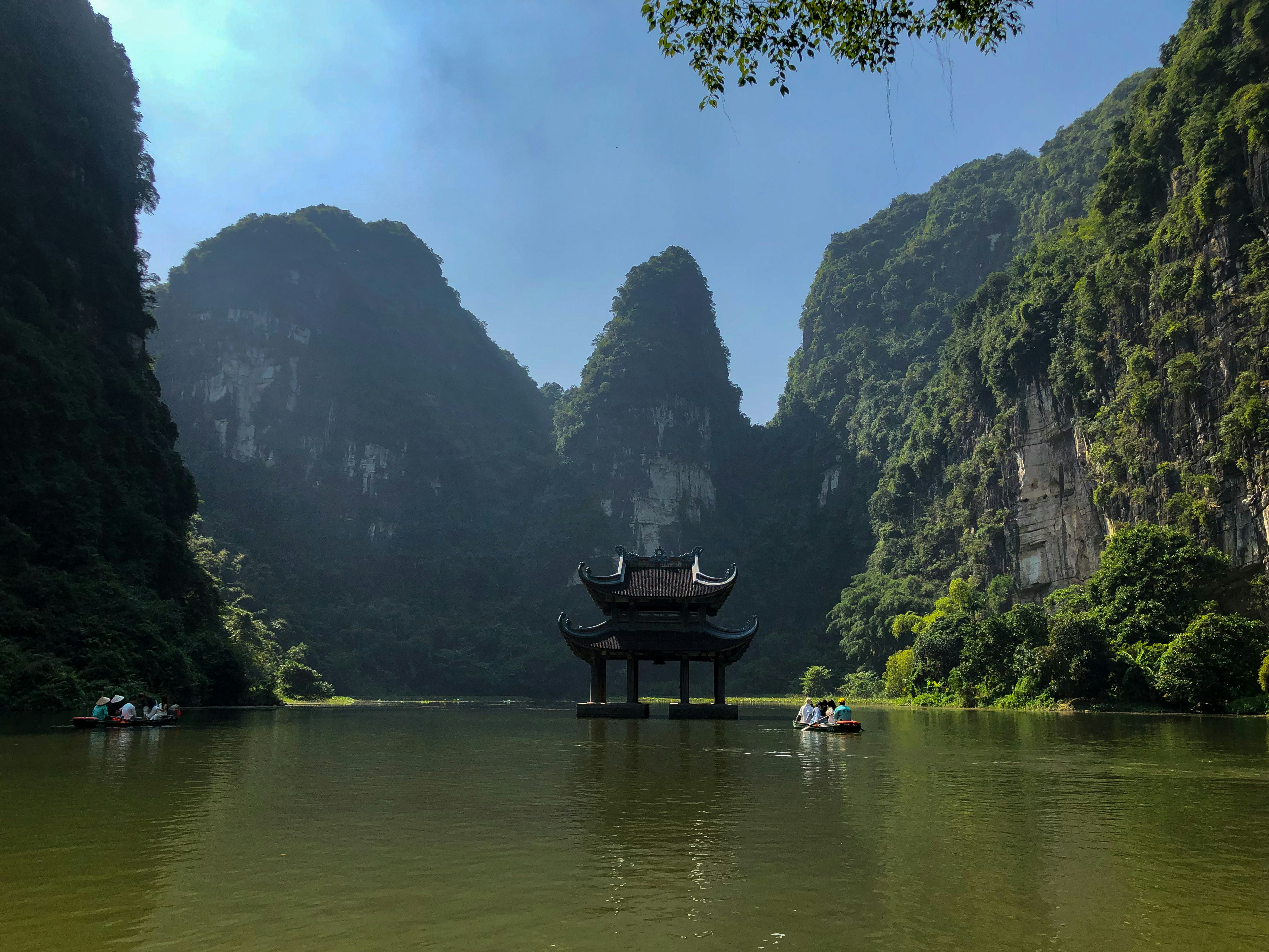 A body of water surrounded by mountains and trees