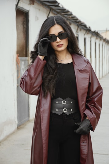 A woman in a black dress and a red leather coat