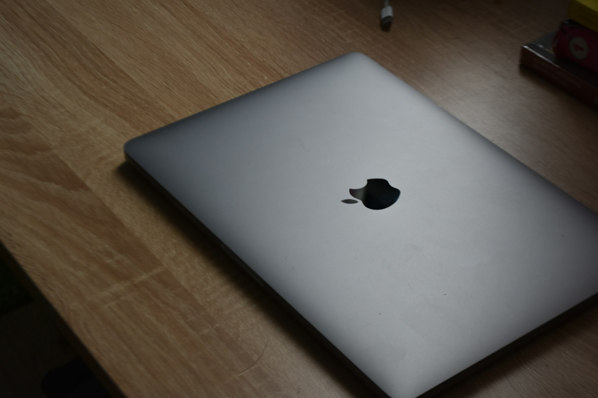 A laptop computer sitting on top of a wooden desk