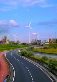 A highway with wind turbines in the background