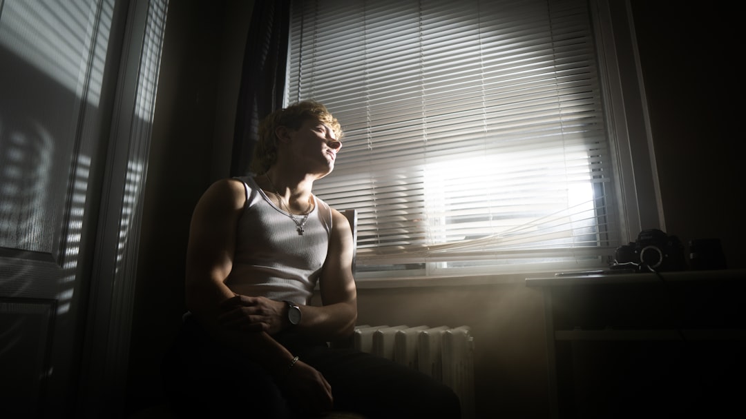 exhausted middle aged woman looking out window worried