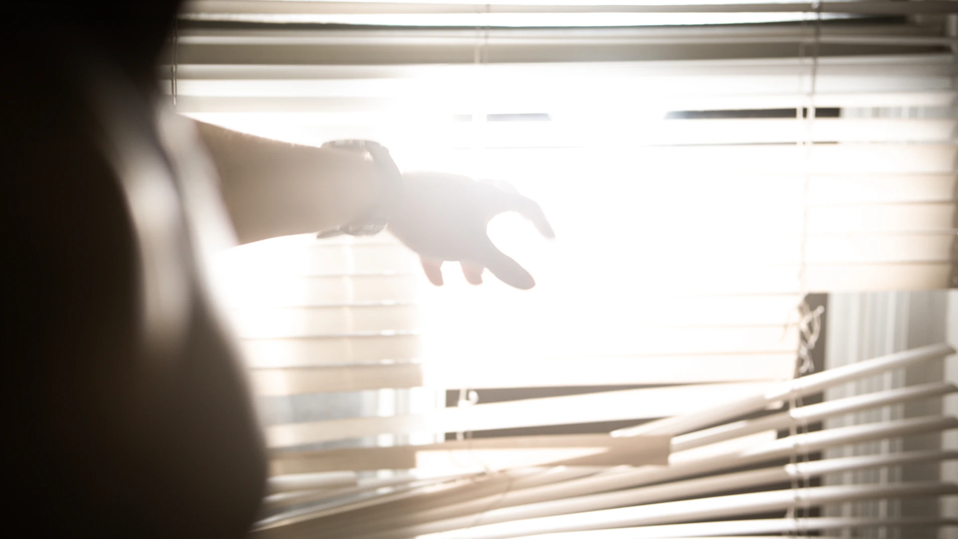 A person reaching out of a window with their hand
