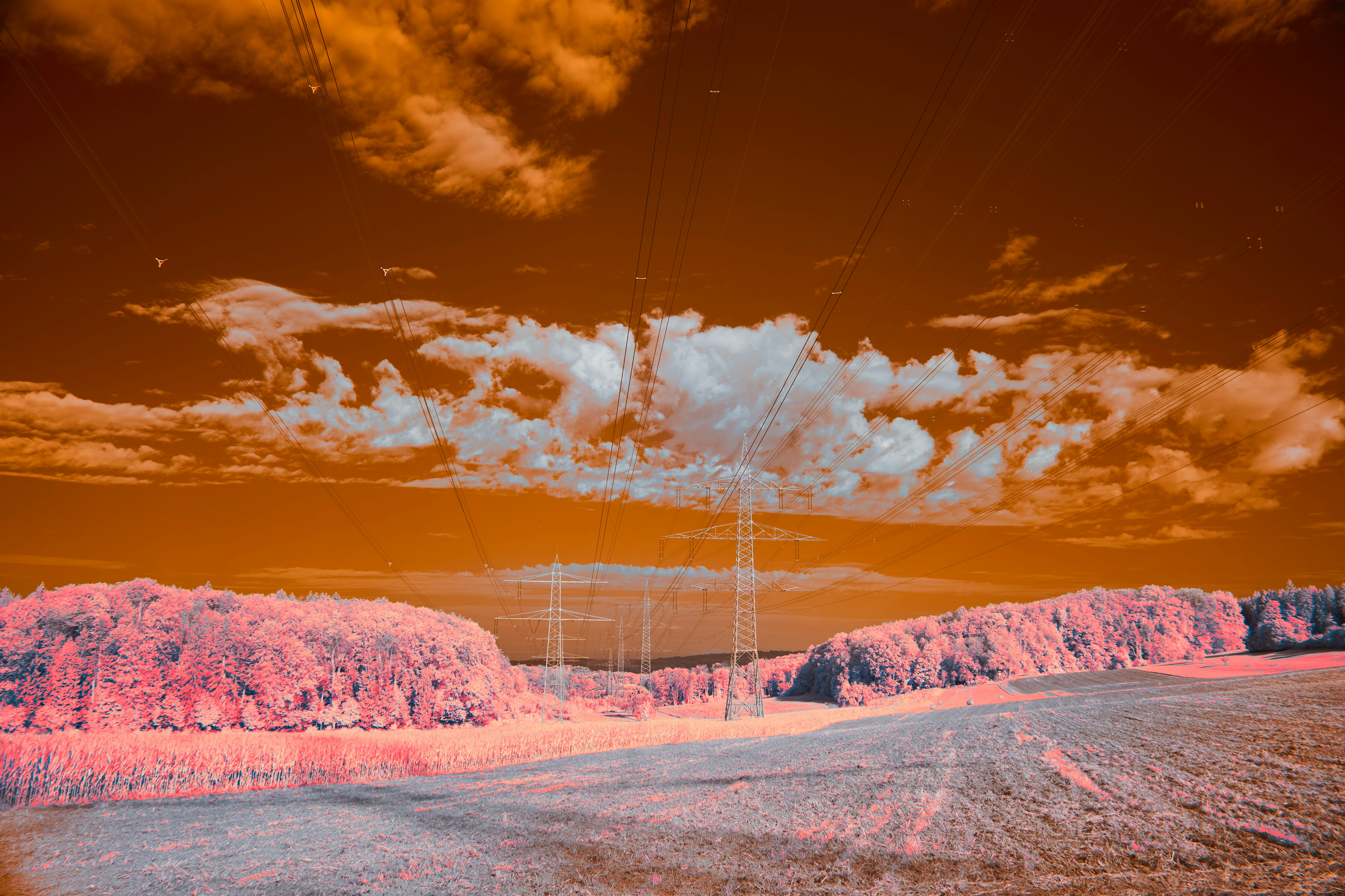 An artistic rendering of a futuristic nuclear power plant, showing clean lines and integration with a natural landscape, emphasizing safety and environmental harmony.