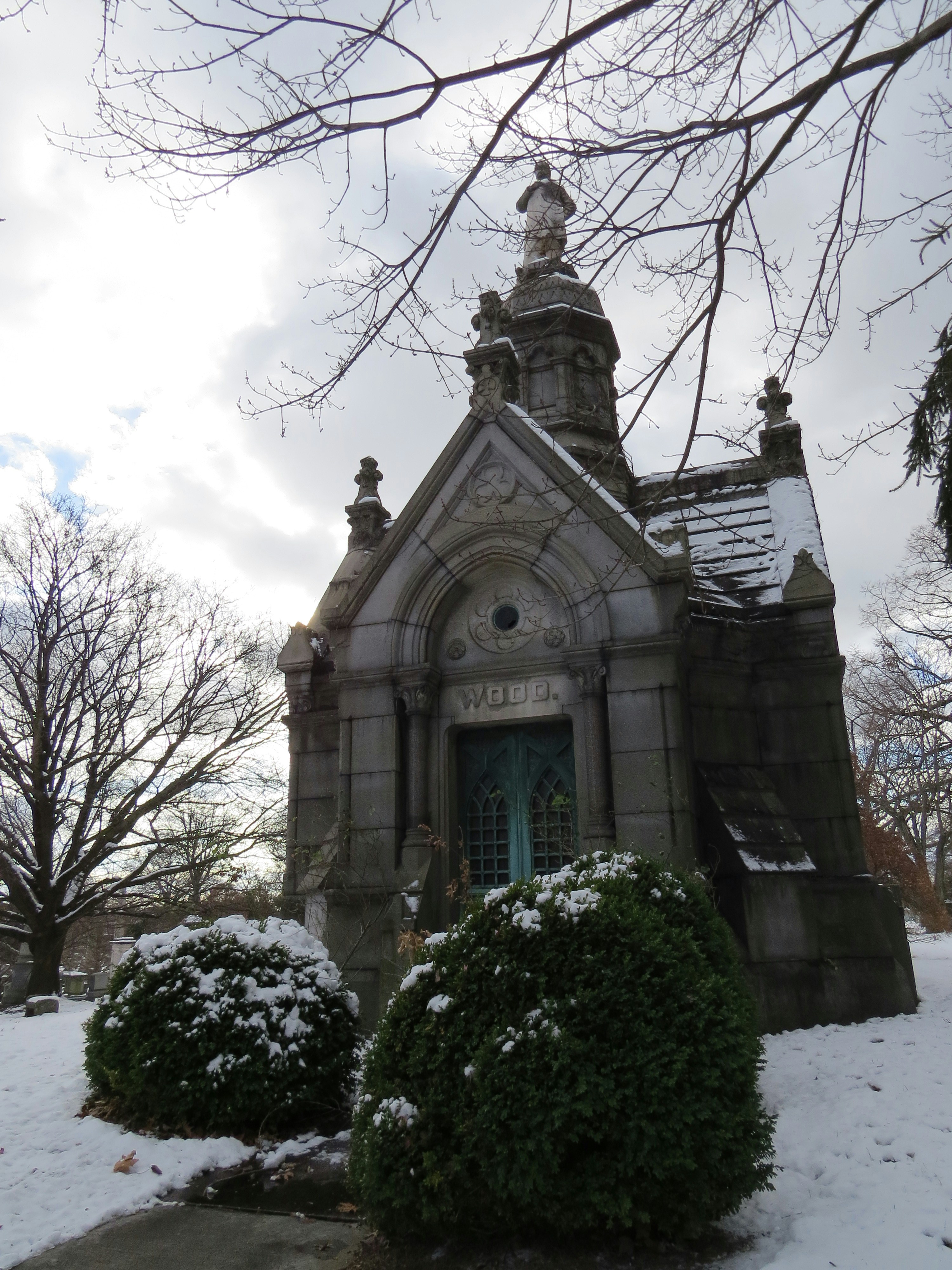 A small church with a clock tower in the snow