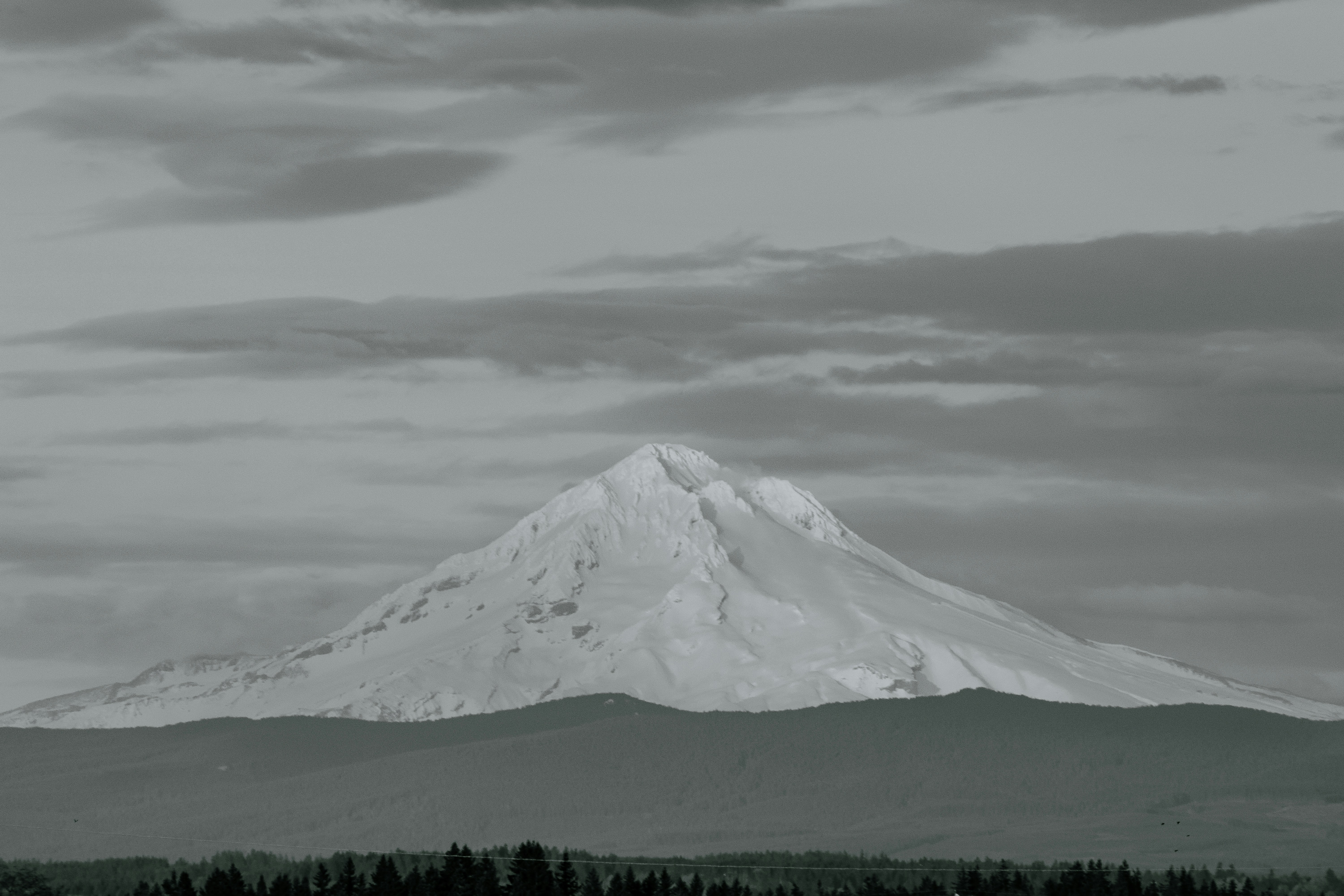 A black and white photo of a snow covered mountain