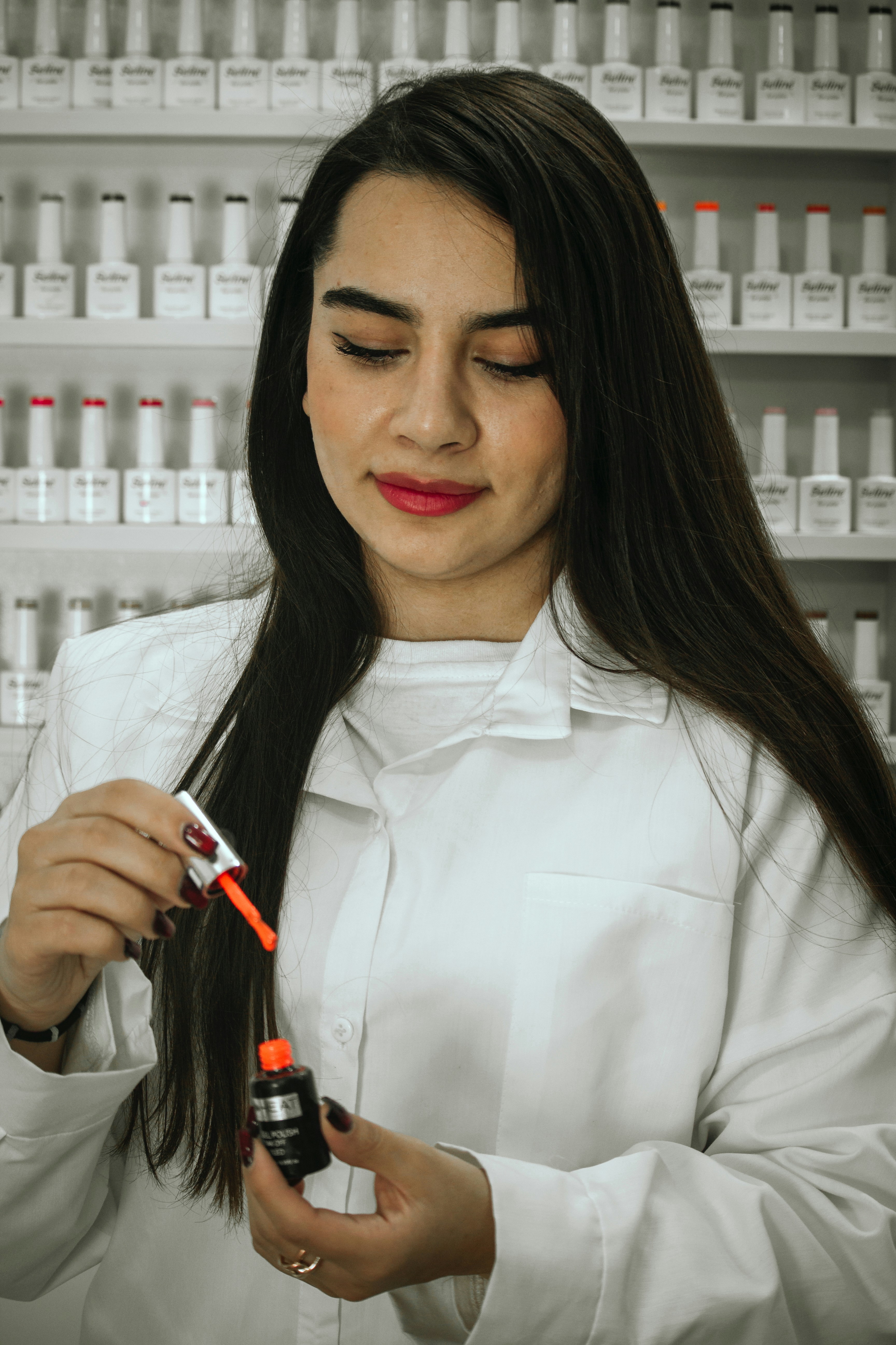 A woman standing in front of a shelf of hair products