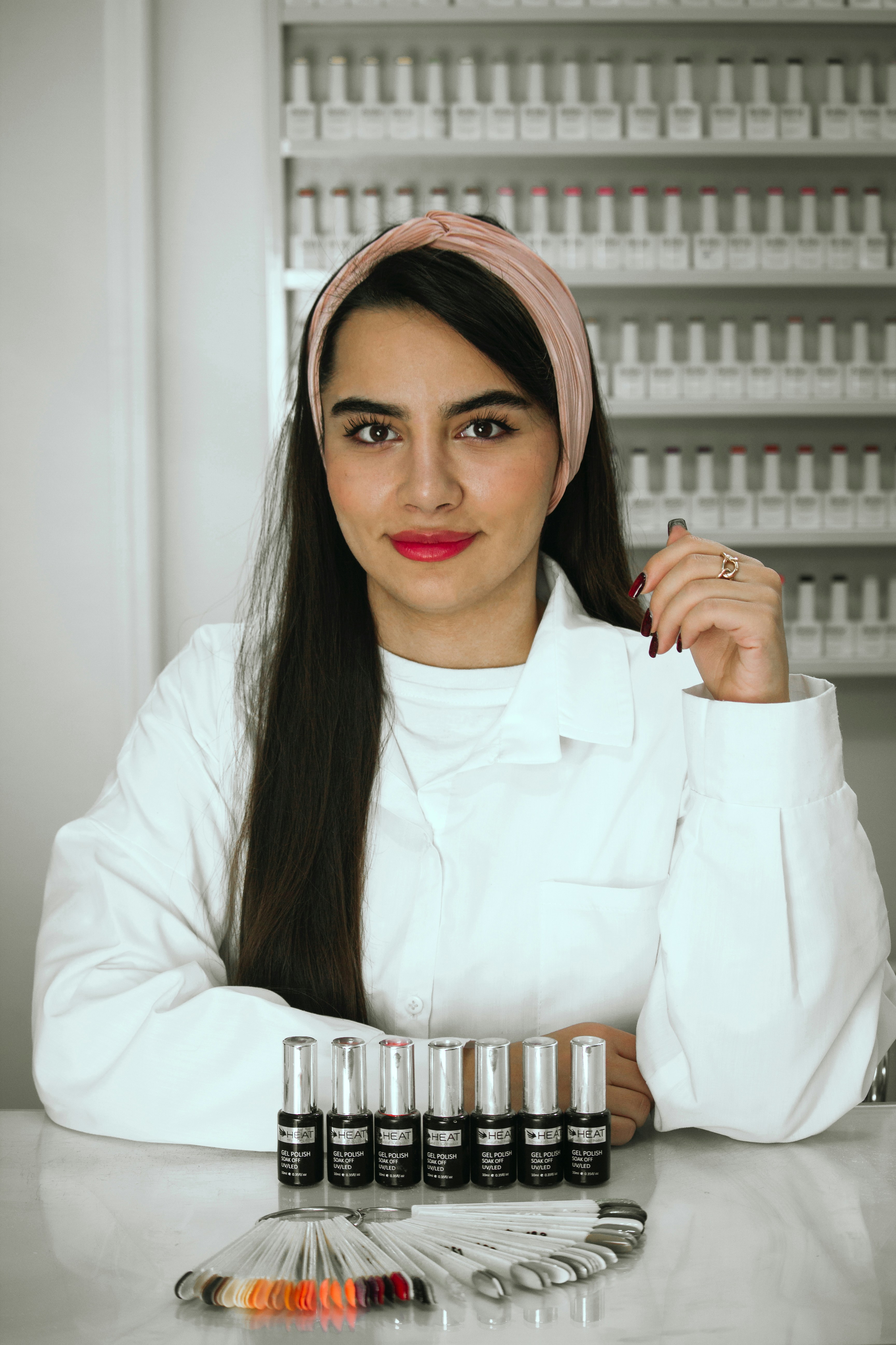 A woman sitting at a table with bottles of pills