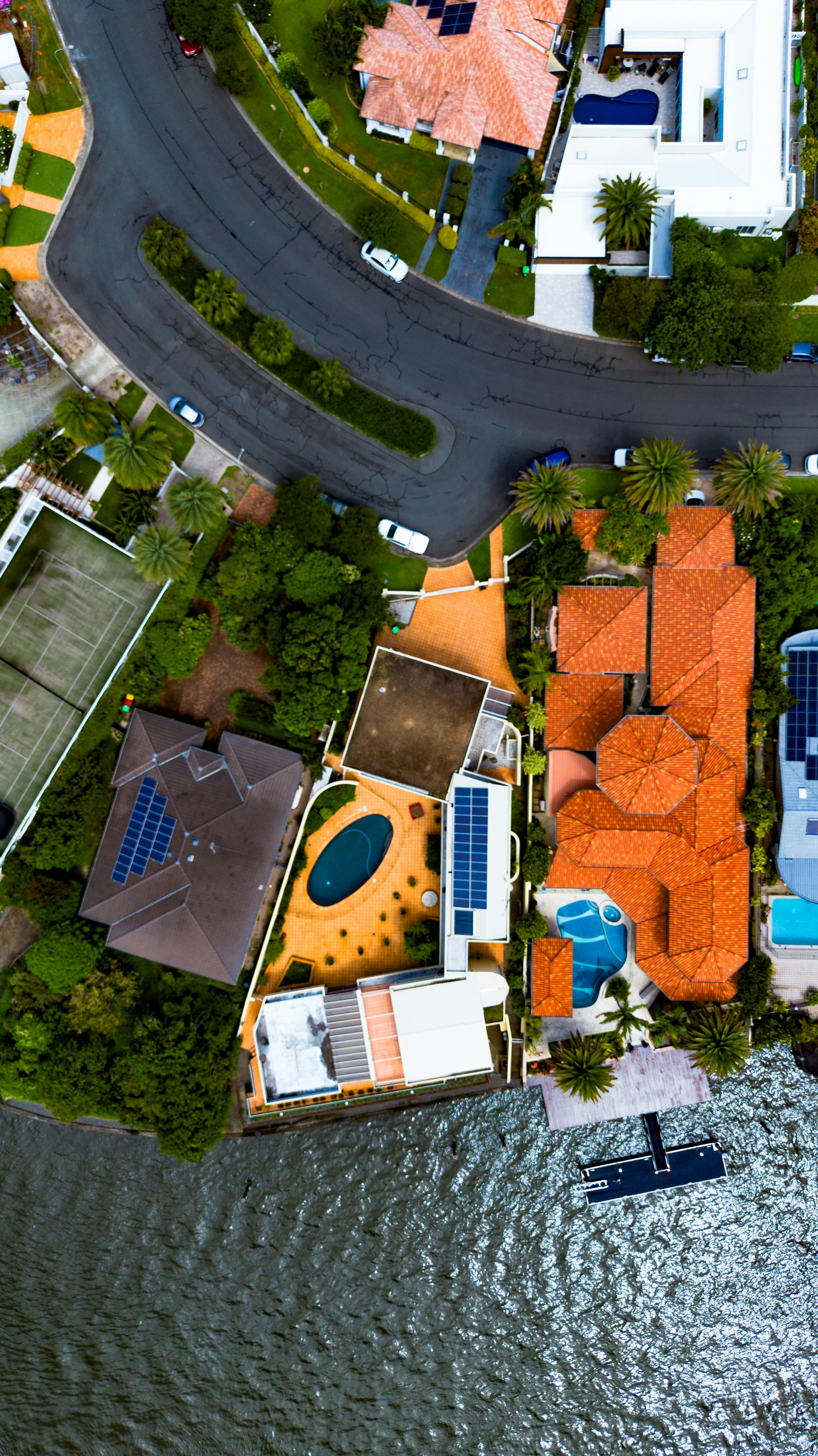 A bird's eye view of a residential area next to a body of water