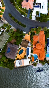 A bird's eye view of a residential area next to a body of water