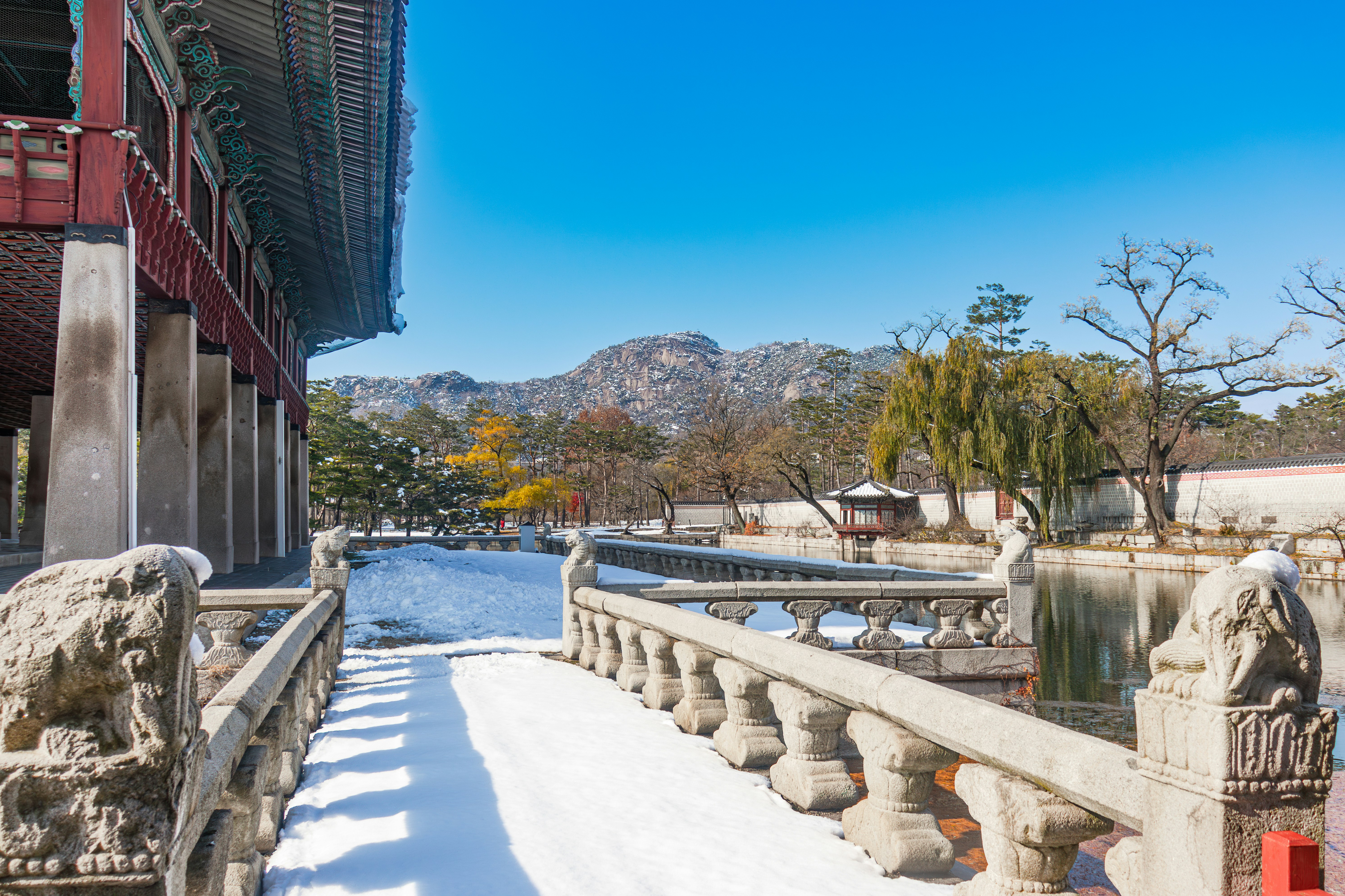 A snow covered walkway next to a building