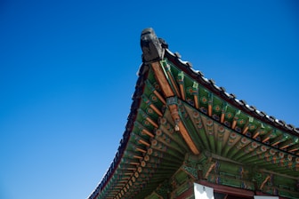 The roof of a building with a blue sky in the background