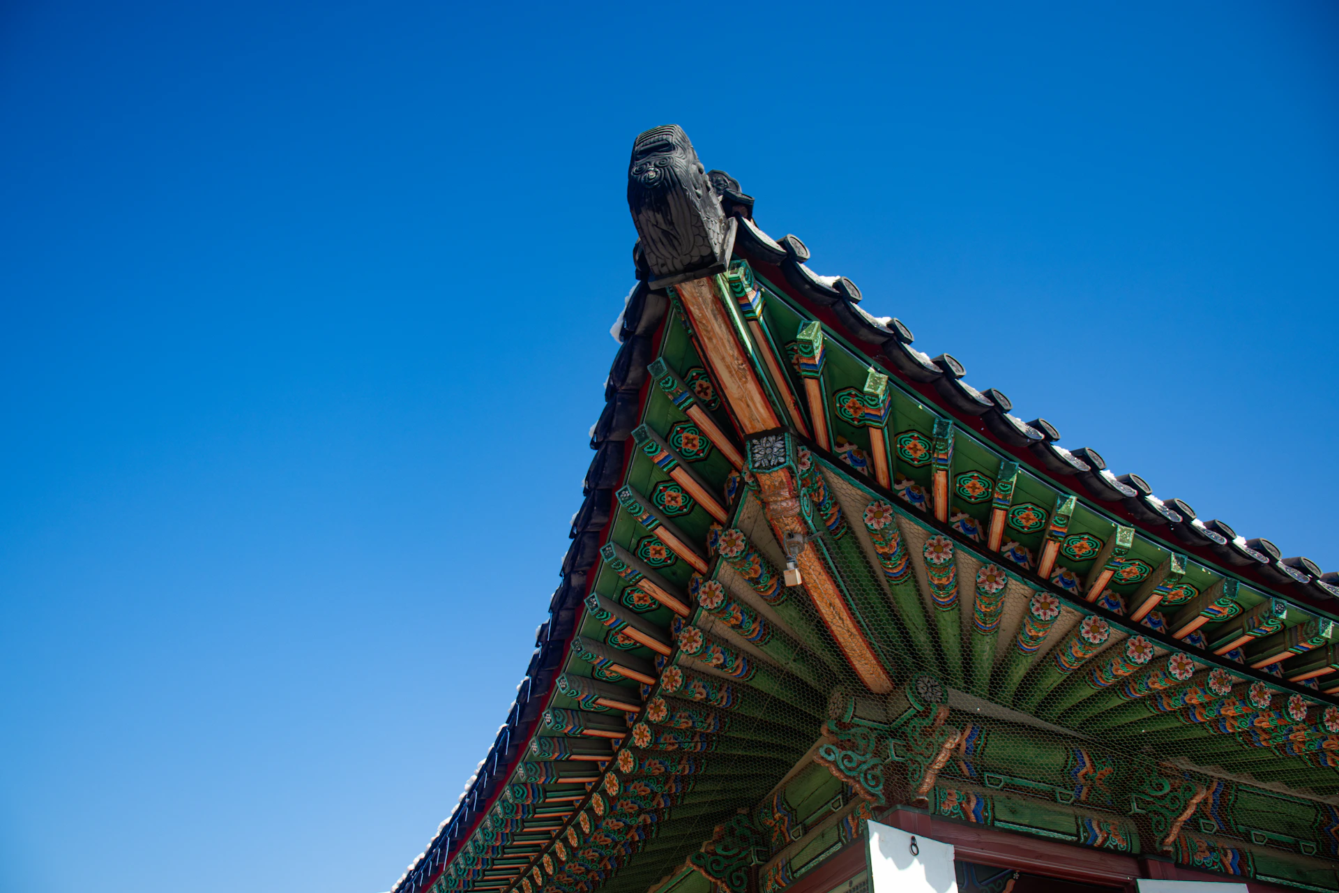 The roof of a building with a blue sky in the background