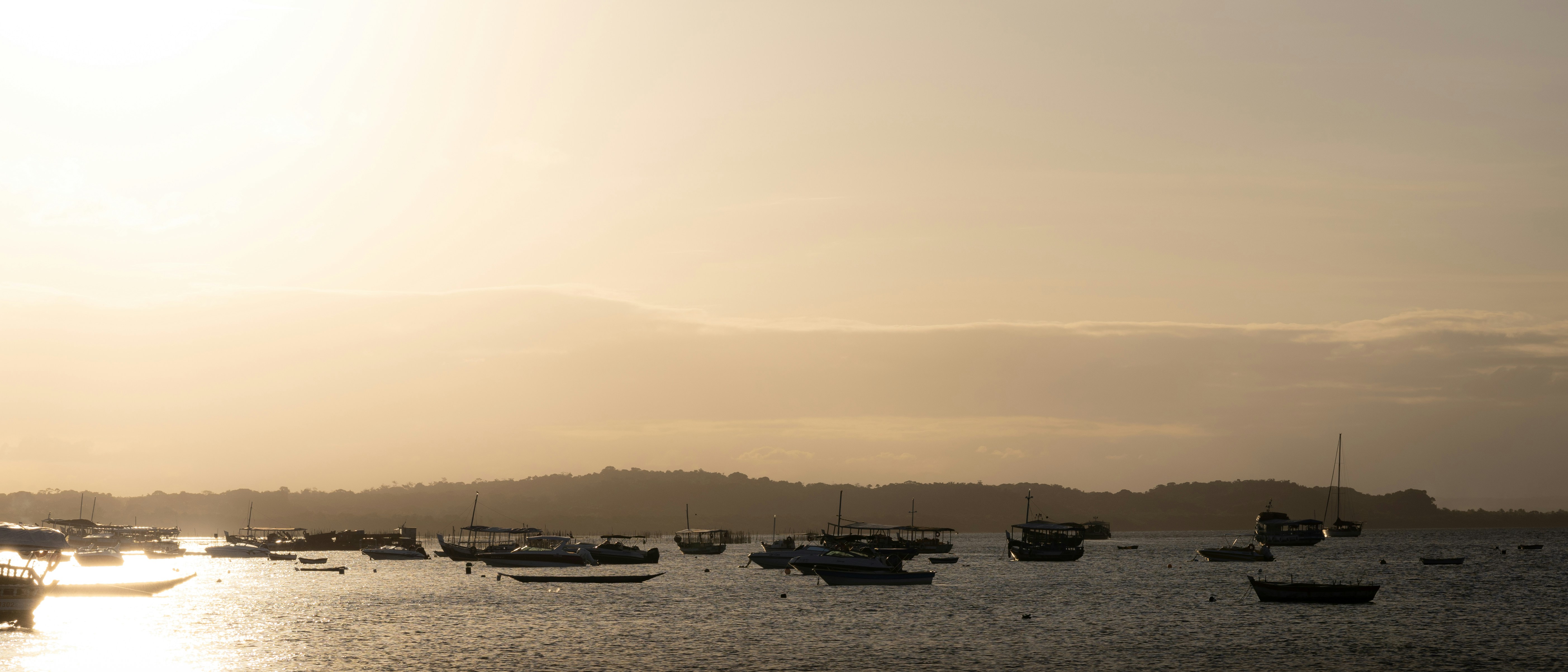 A group of boats floating on top of a body of water