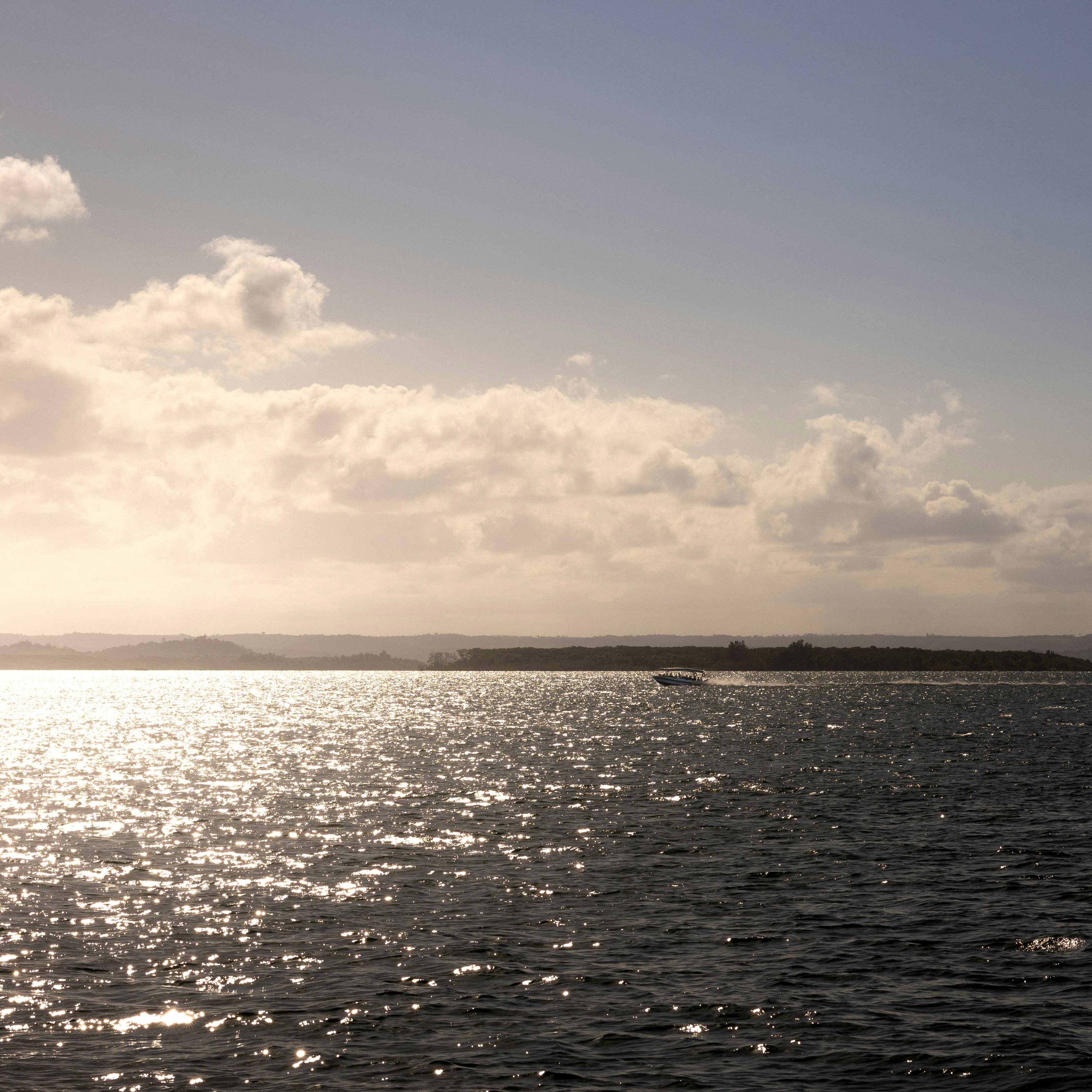 A large body of water sitting under a cloudy sky