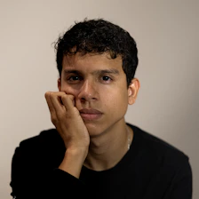 A young man is posing for a picture
