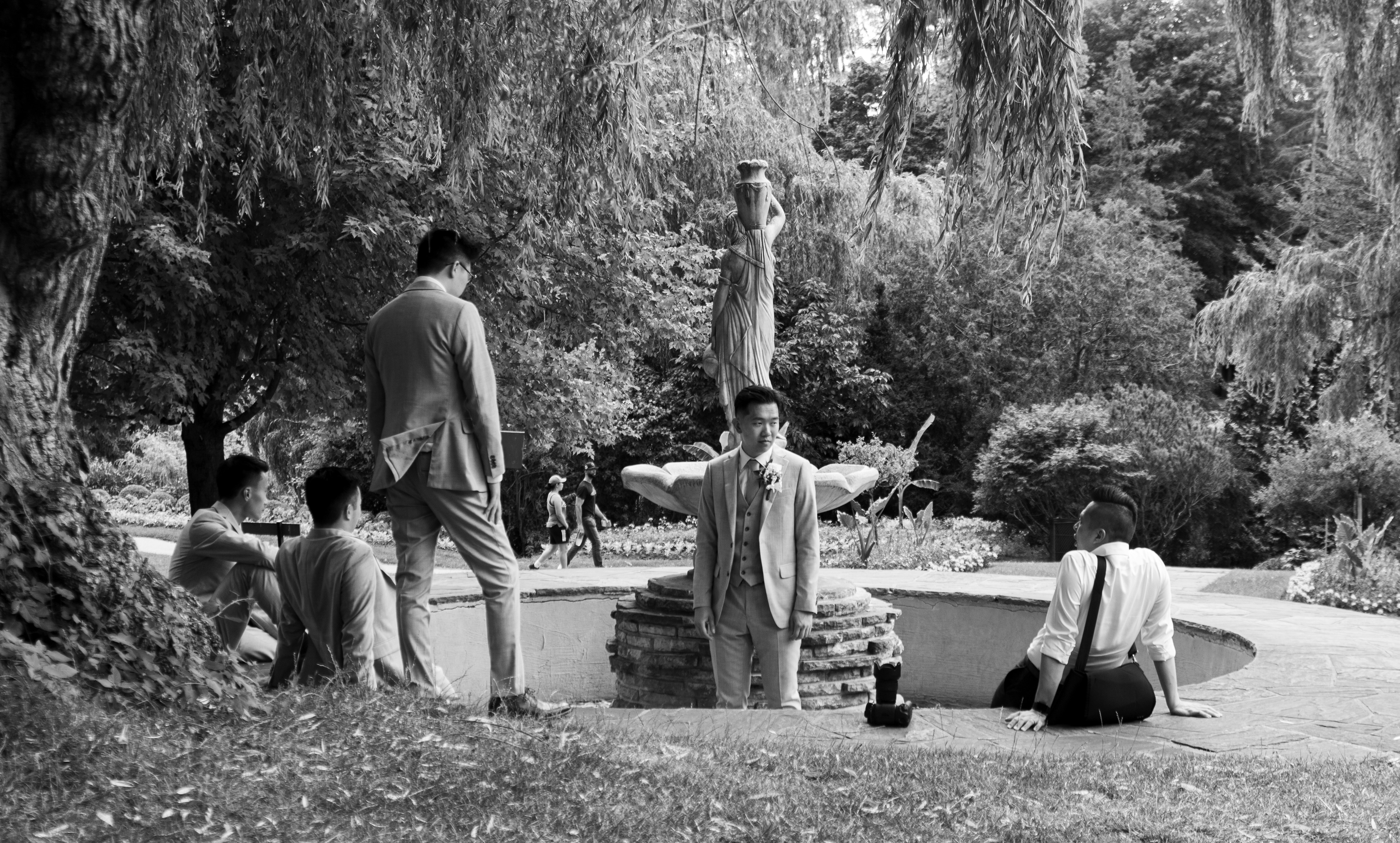 A group of people standing around a pool in a park