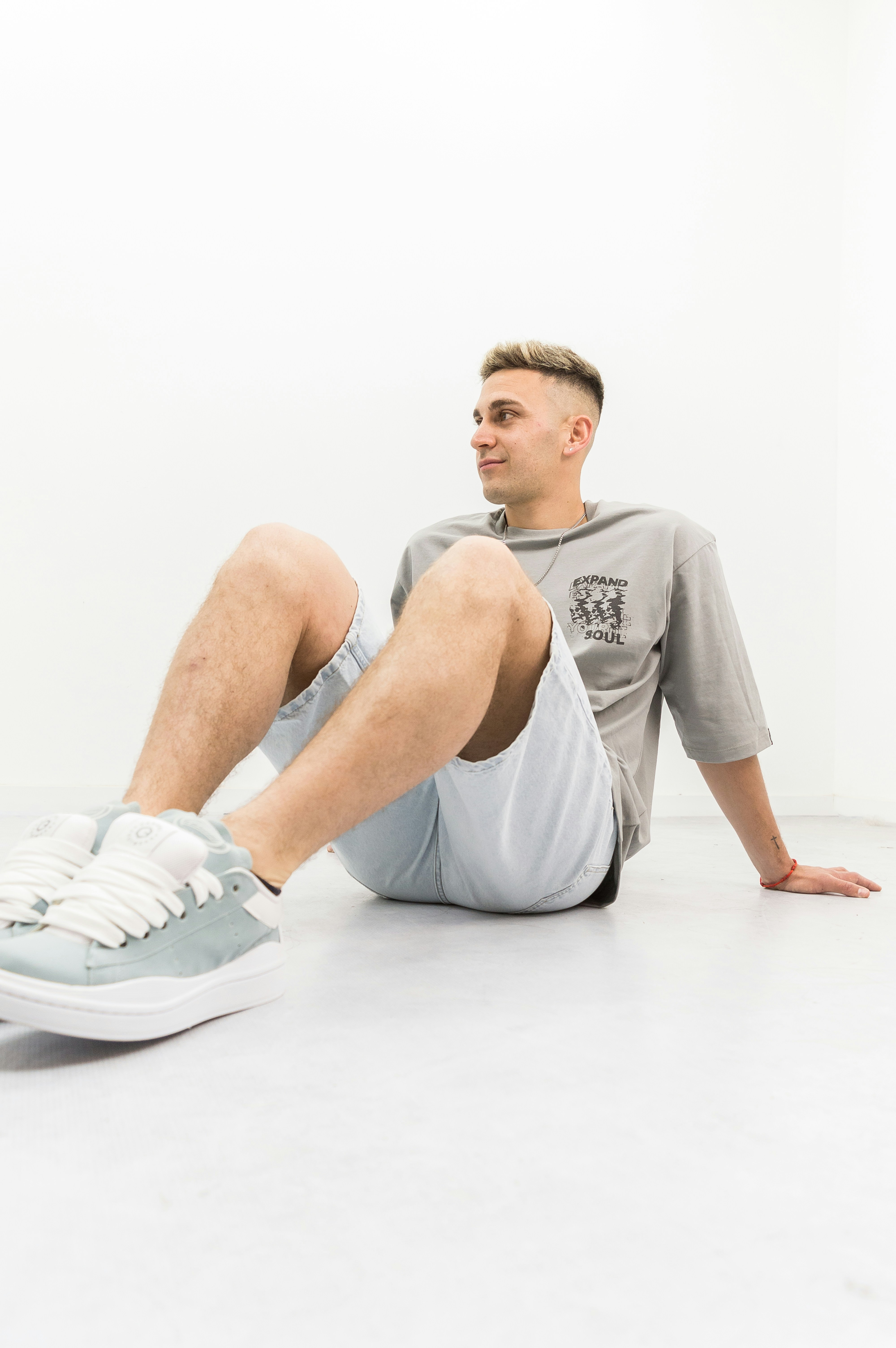 A man sitting on the floor with his legs crossed