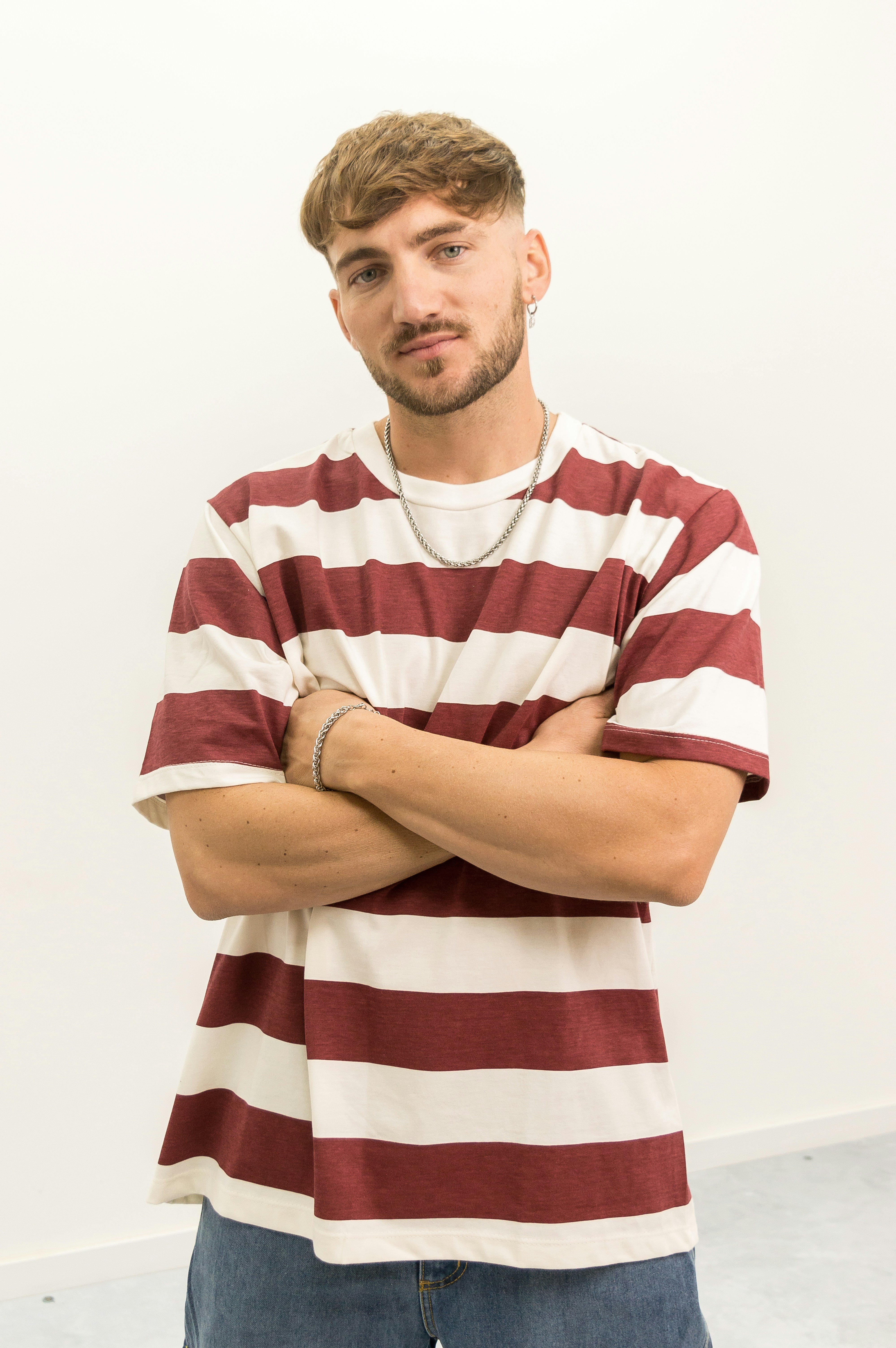 A man standing in front of a white wall