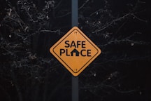A yellow sign that says safe place on it