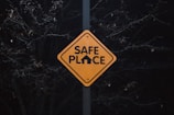 A yellow sign that says safe place on it