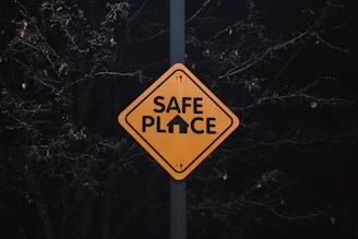 A yellow sign that says safe place on it