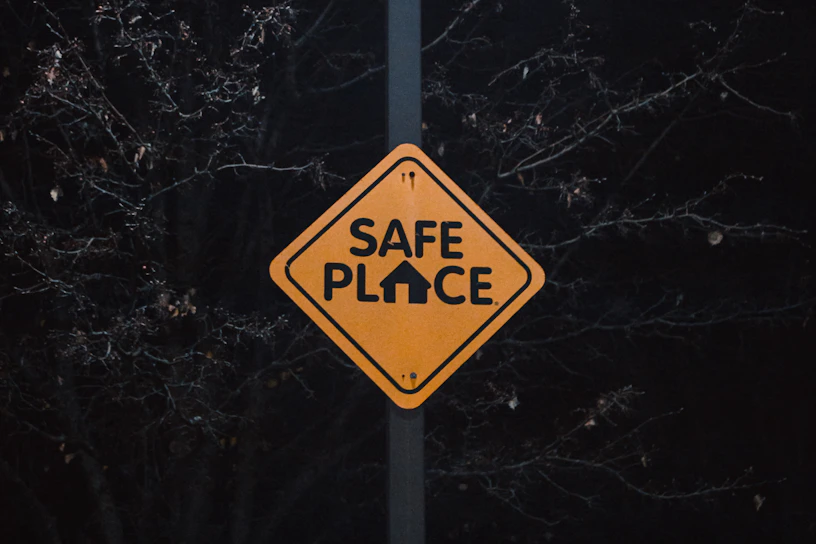 A yellow sign that says safe place on it