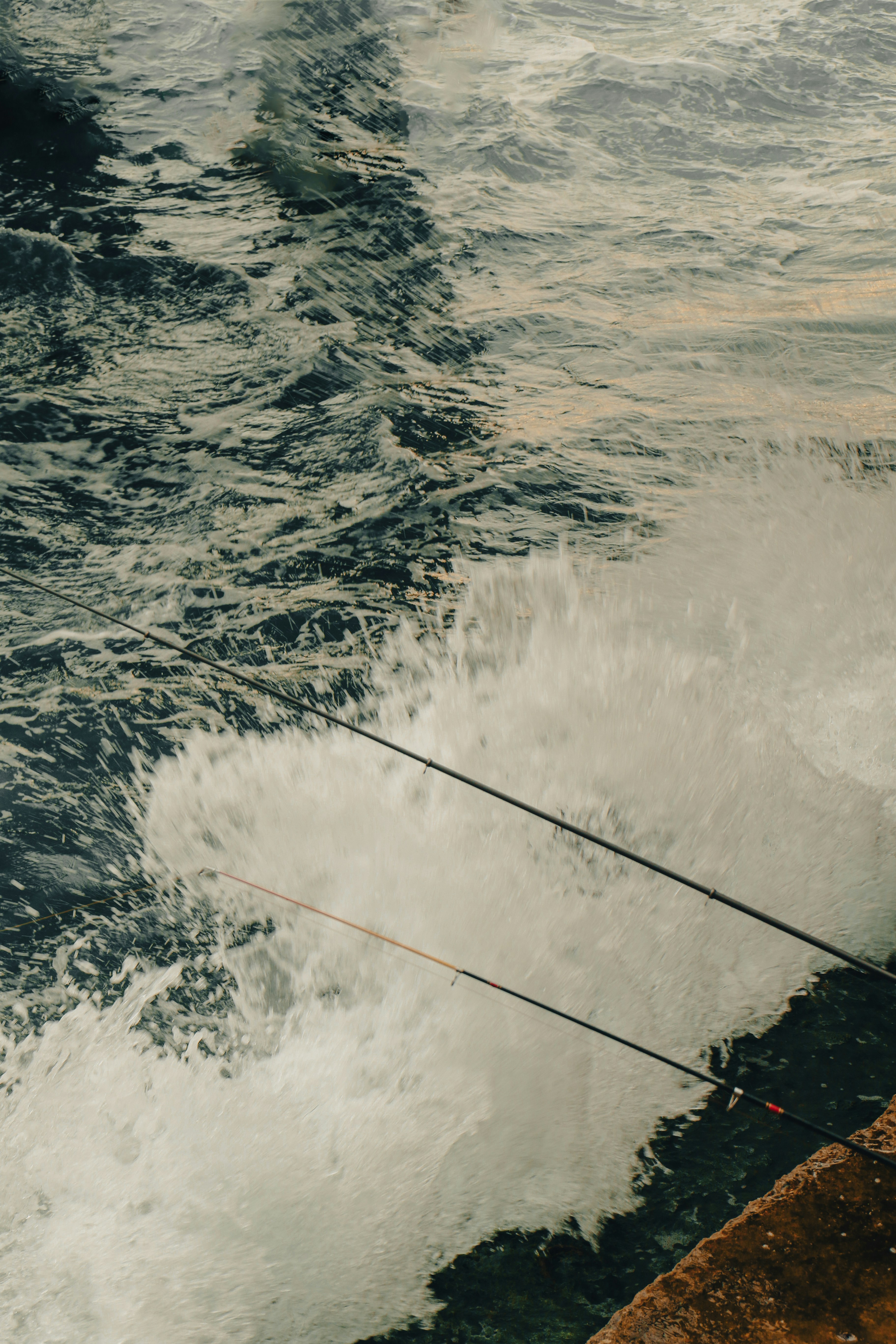 A man standing on a dock holding a fishing pole