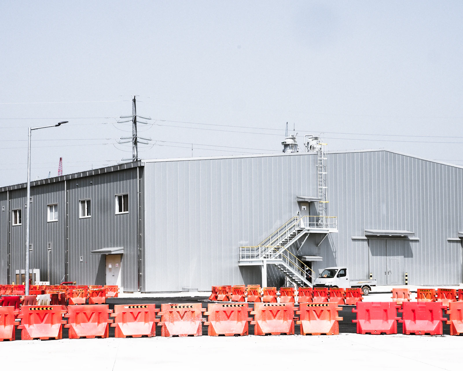  Workers in PPE loading chemical drums into a container at a Shanghai industrial facility in mid-May 2022 as the city begins phased reopening after the eight-week lockdown 