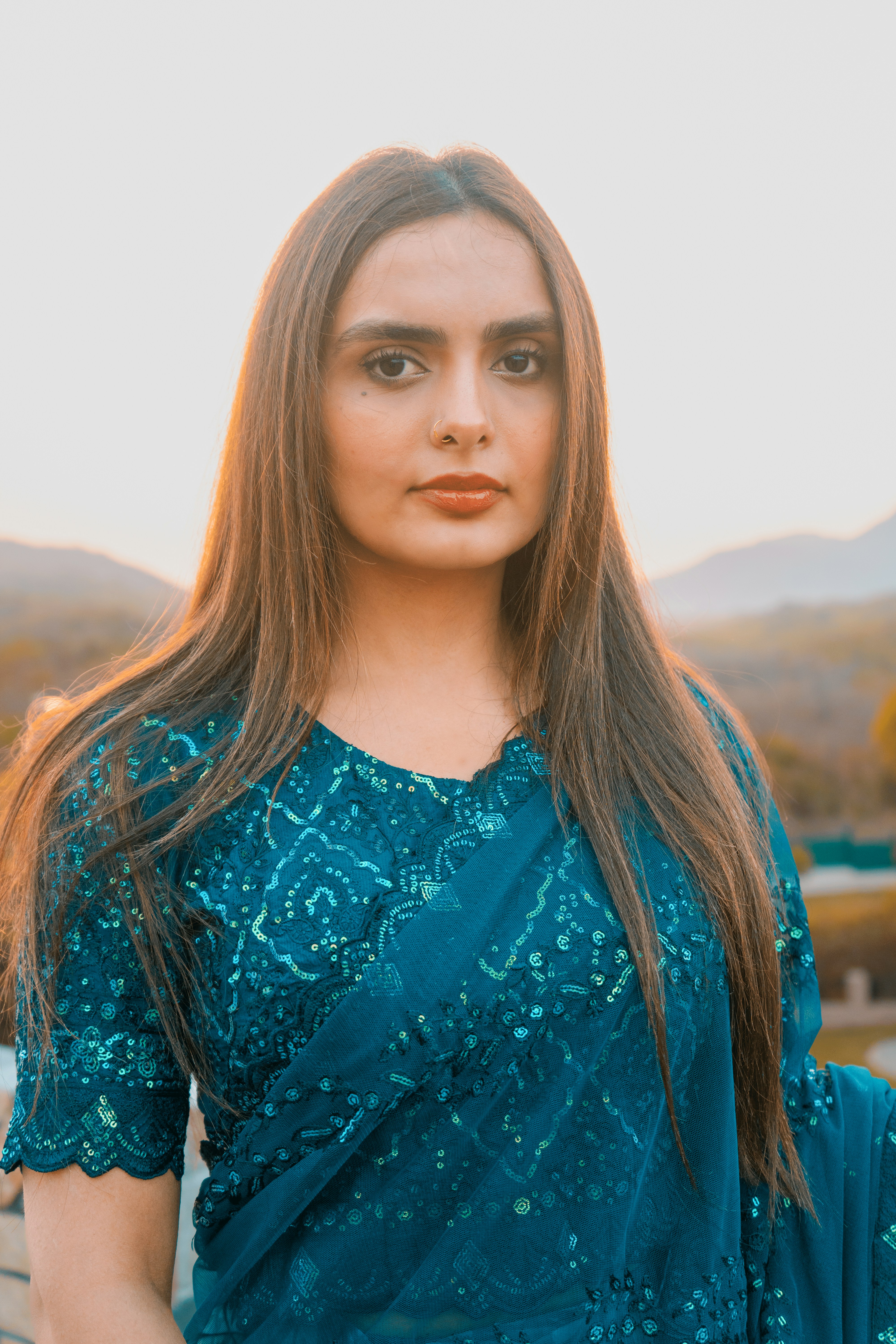 A woman in a blue dress posing for a picture
