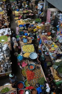 A group of people standing around a market