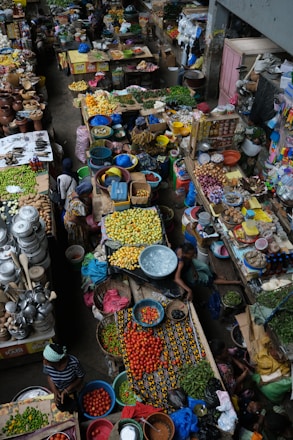 A group of people standing around a market