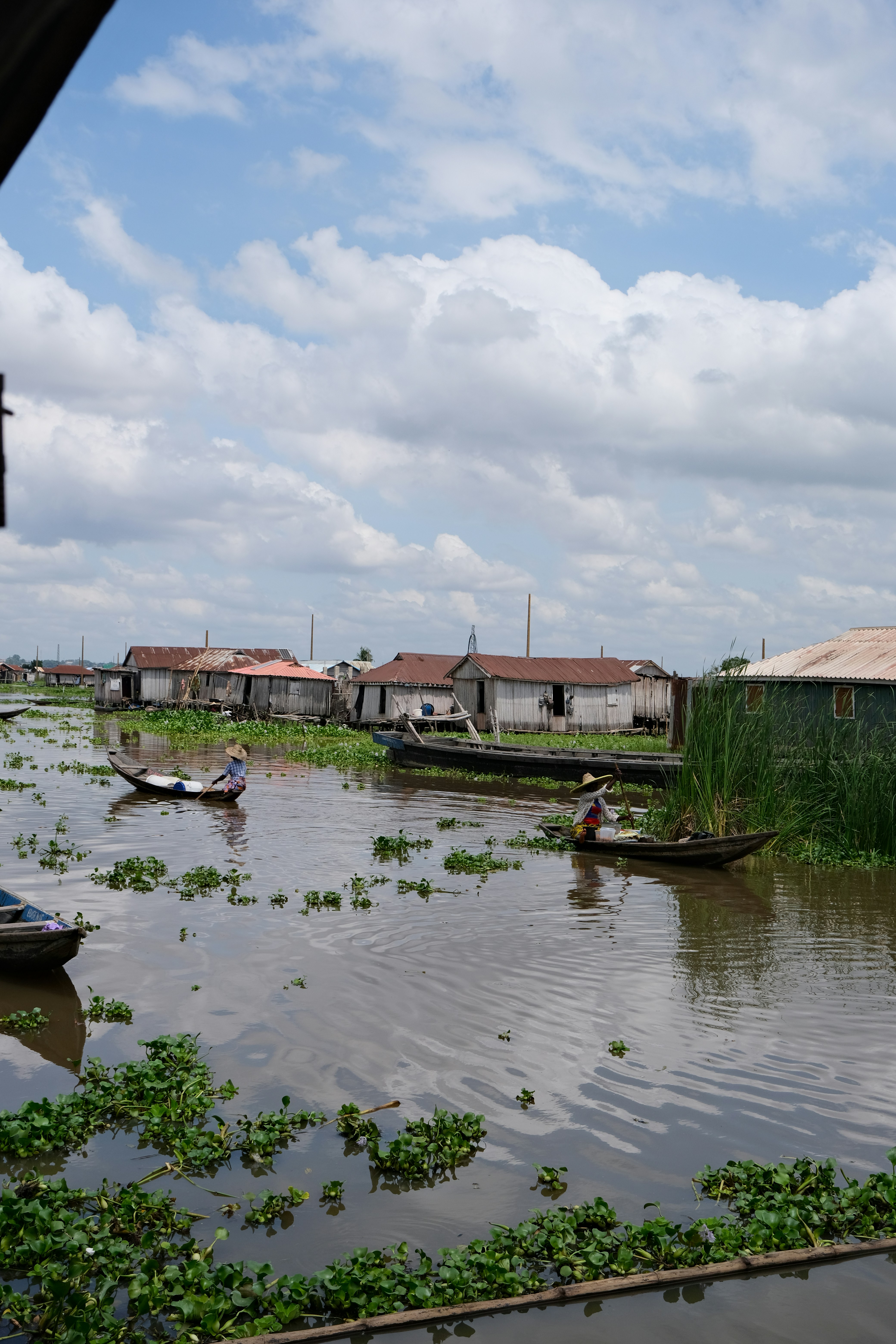 A group of boats floating on top of a river