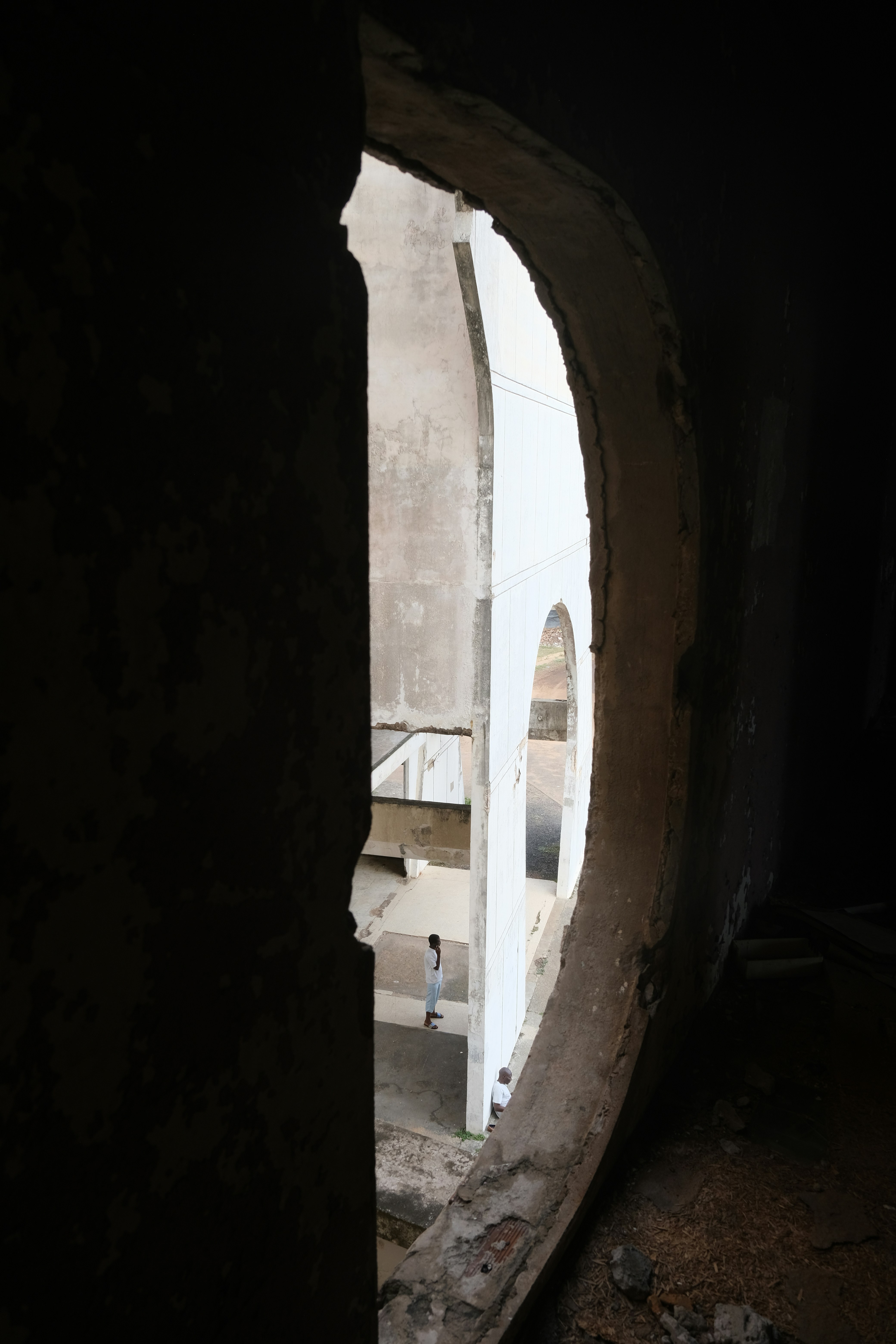 A view of a building through a hole in the wall