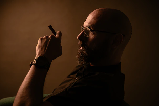A man holding a cigarette in his right hand