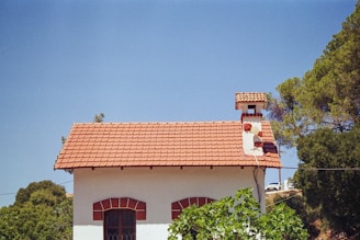 A small white house with a red roof