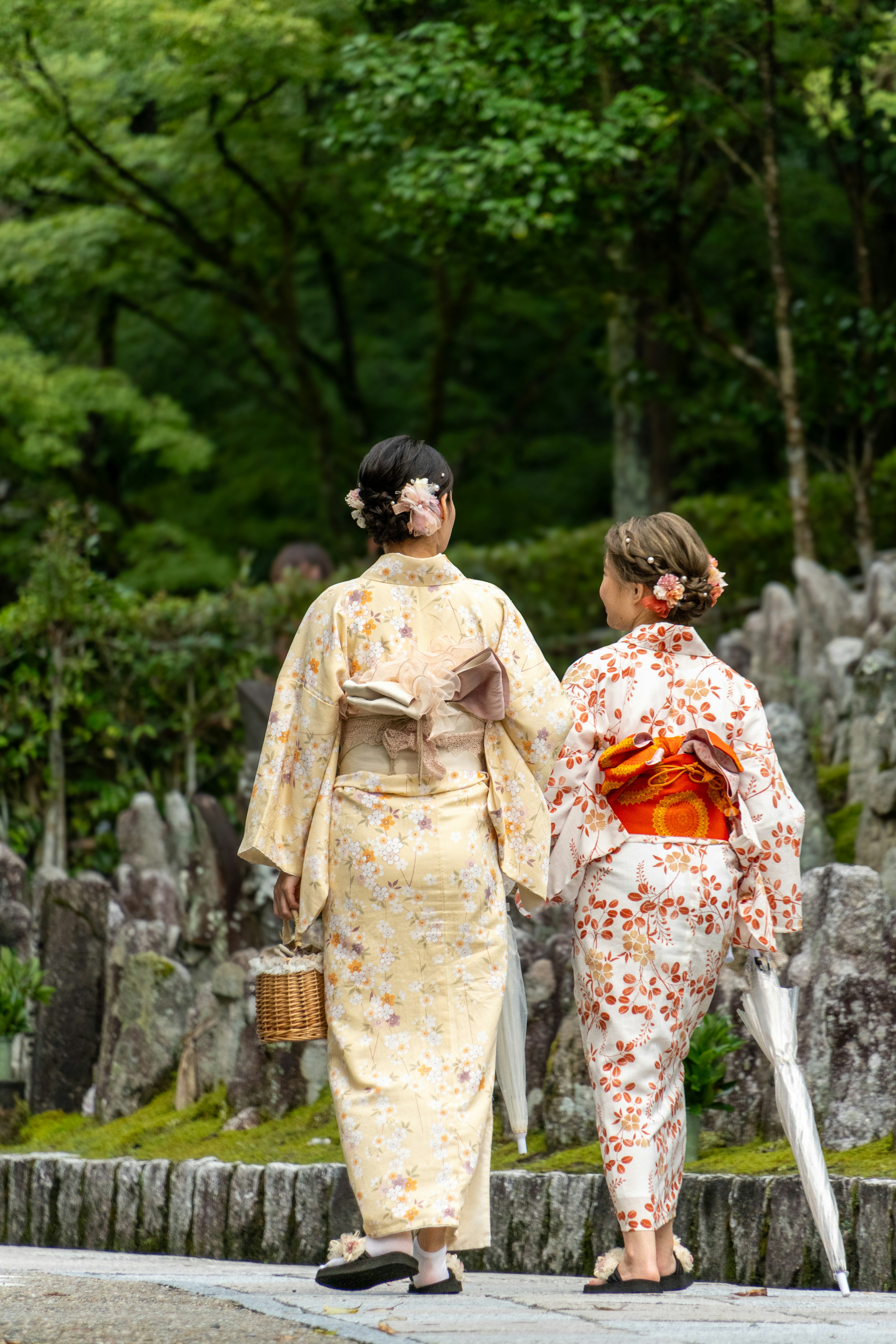 A couple of women walking down a street photo – Free Portrait Image on ...